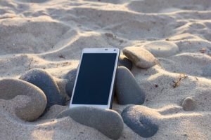 phone on beach sand